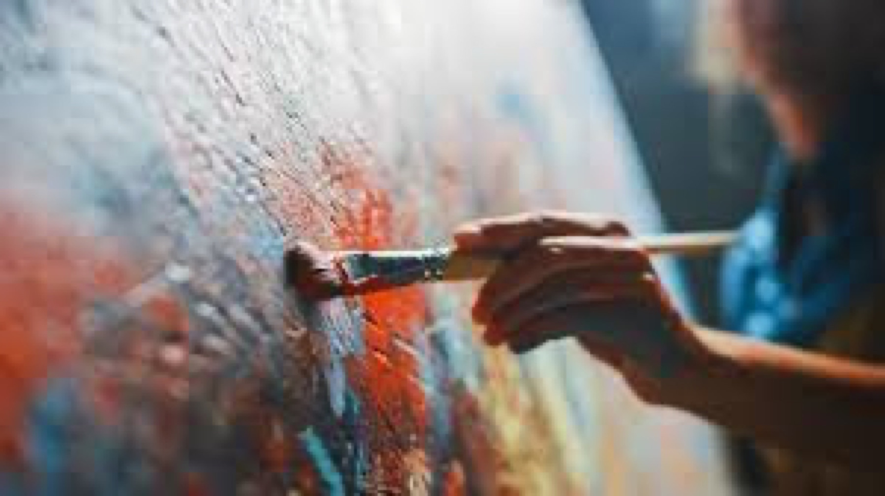An artist at work with a loaded brush